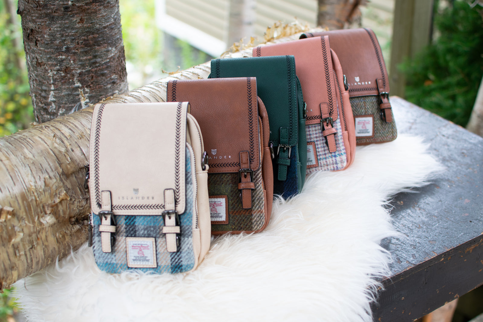 Pink crossbody bag with plaid pattern on a white surface