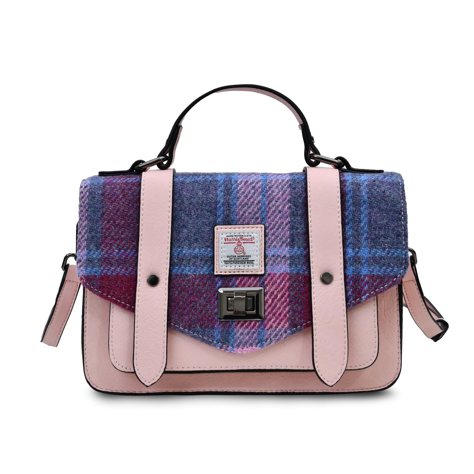 Pink and blue plaid handbag on a wooden surface with a blurred outdoor background